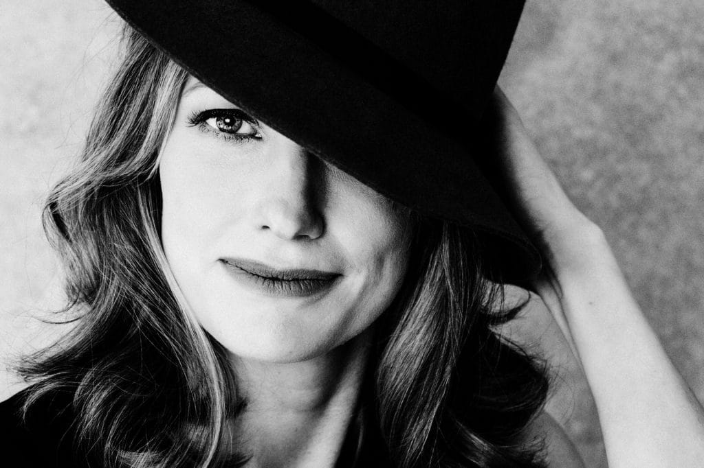 Close up image of a woman wearing a hat for boudoir photo