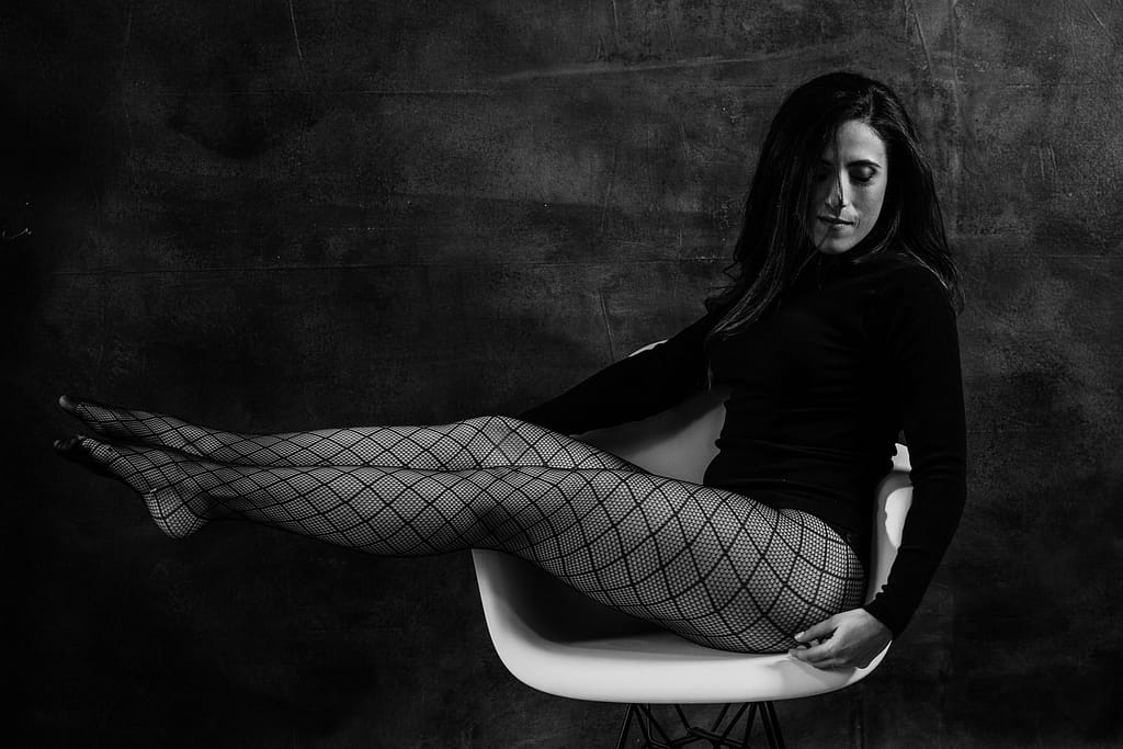 Black and white boudoir photo shoot of woman wearing fishnets. Boudoir photography coquitlam