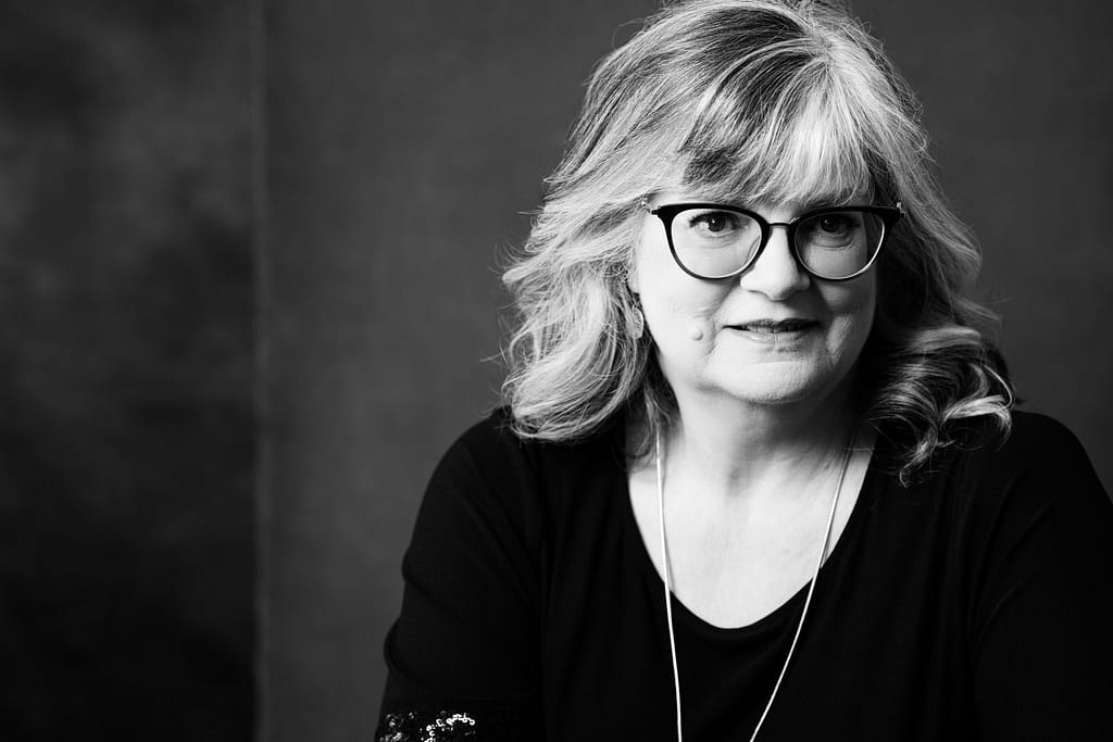 Black and white headshot of a woman with glasses. Headshot photography Vancouver.