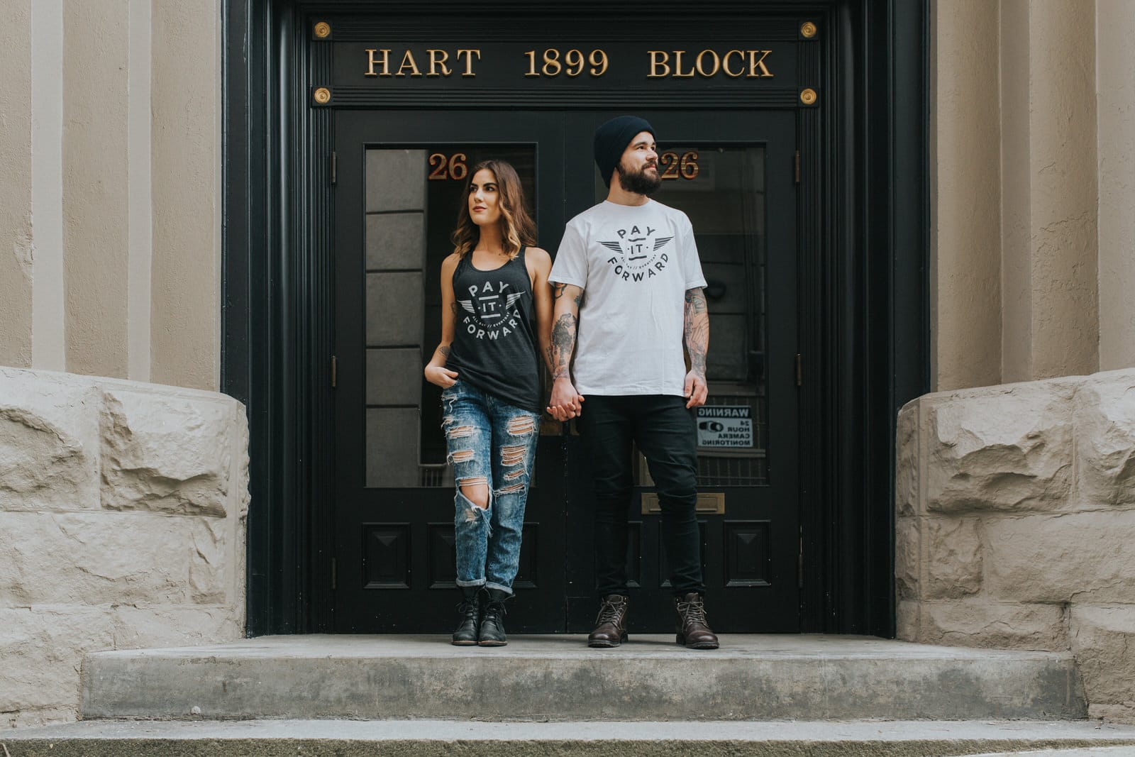 Two people stood in front of a vintage door way modelling a local vancouver clothing line for their personal branding photos. 