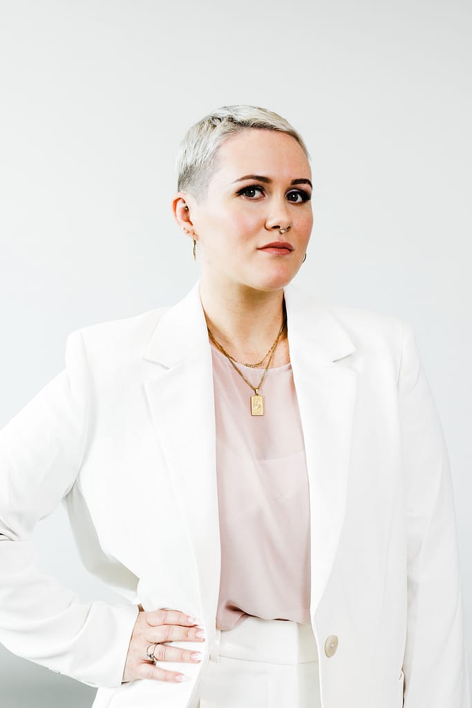Headshot of short silver hair woman standing with hand on hip. Coquitlam headshot studio