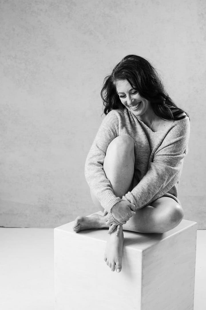vancouver boudoir image of woman sitting and hugging legs