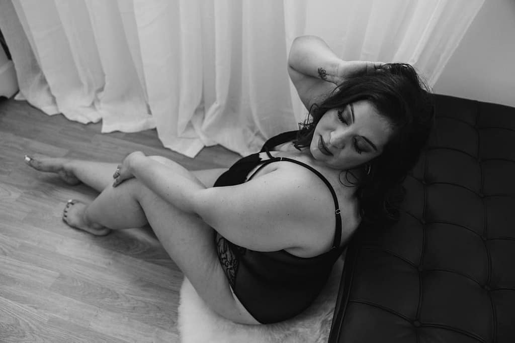 Boudoir photography vancouver Black and white portrait of plus size woman sitting on floor