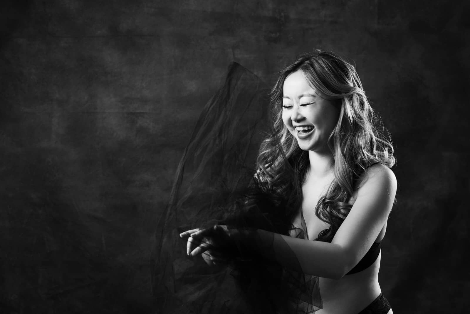 Vancouver Boudoir PhotoShoot Black and white portrait of a woman laughing Vancouver Mateus Studios