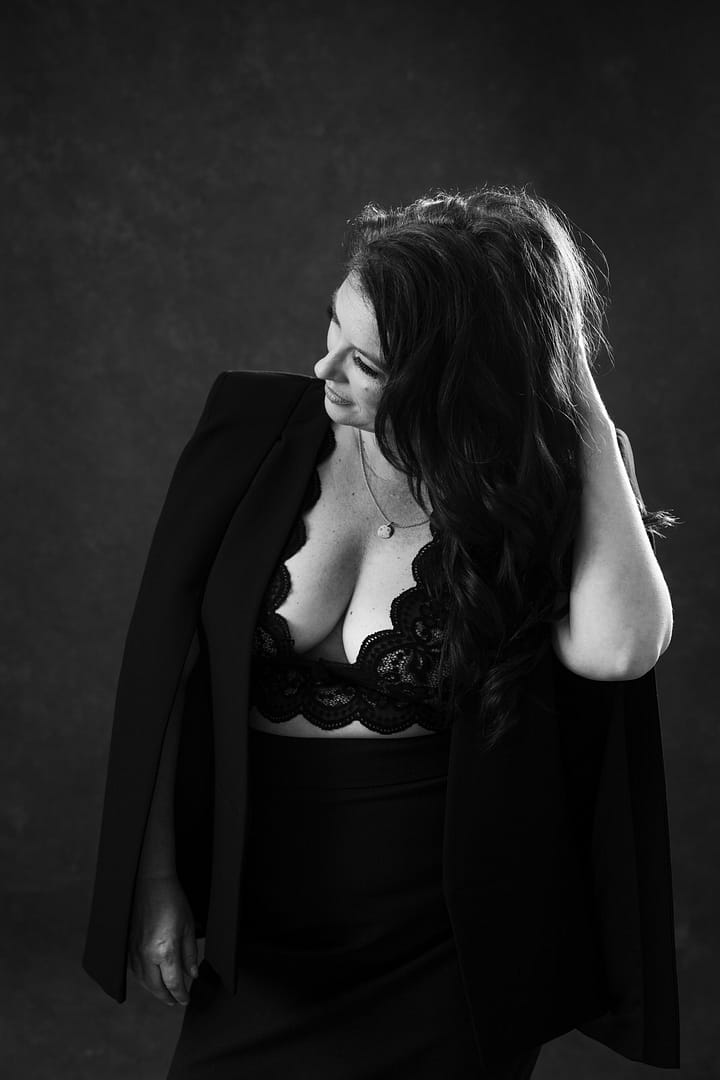boudoir image of woman wearing low cut lace top revealing cleavage