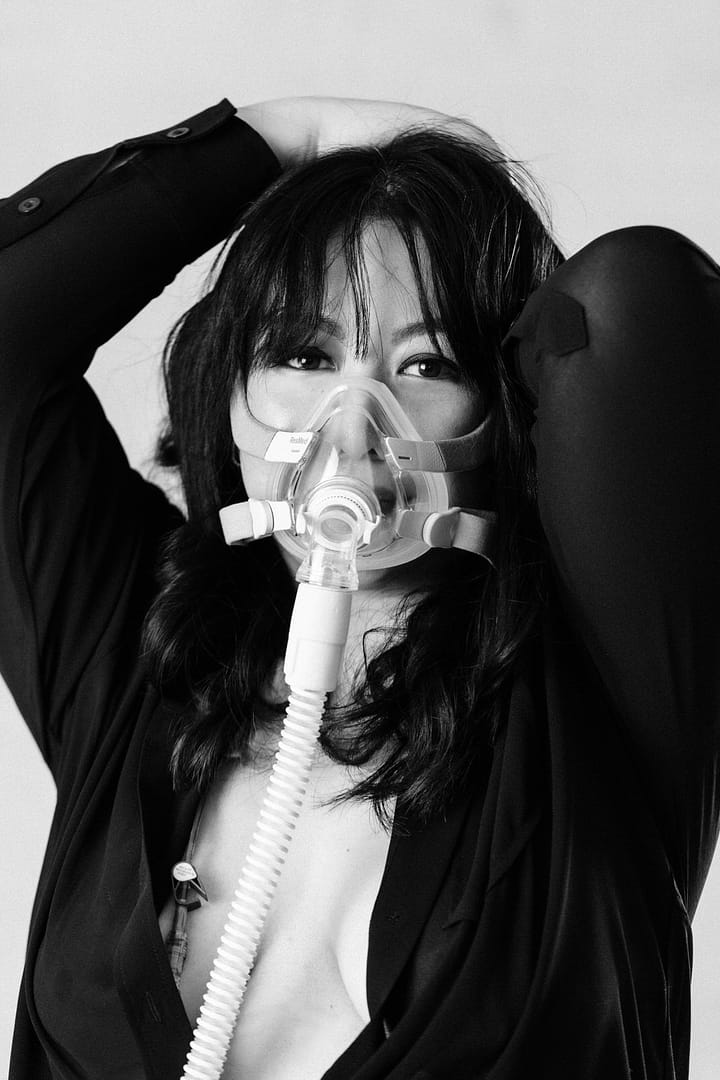 empowering portraits boudoir image of woman wearing an oxygen mask and lingerie